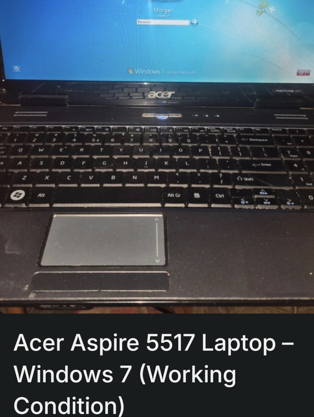Acer Black and Silver Laptop with Windows 7 Login Screen.